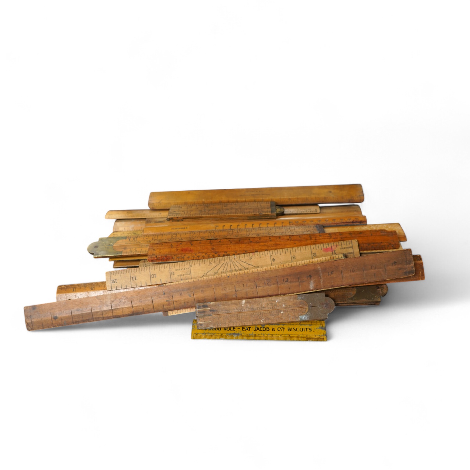 A large collection of thirty Antique and Vintage boxwood rules including the Jacob's Biscuits metal ruler. c.1900